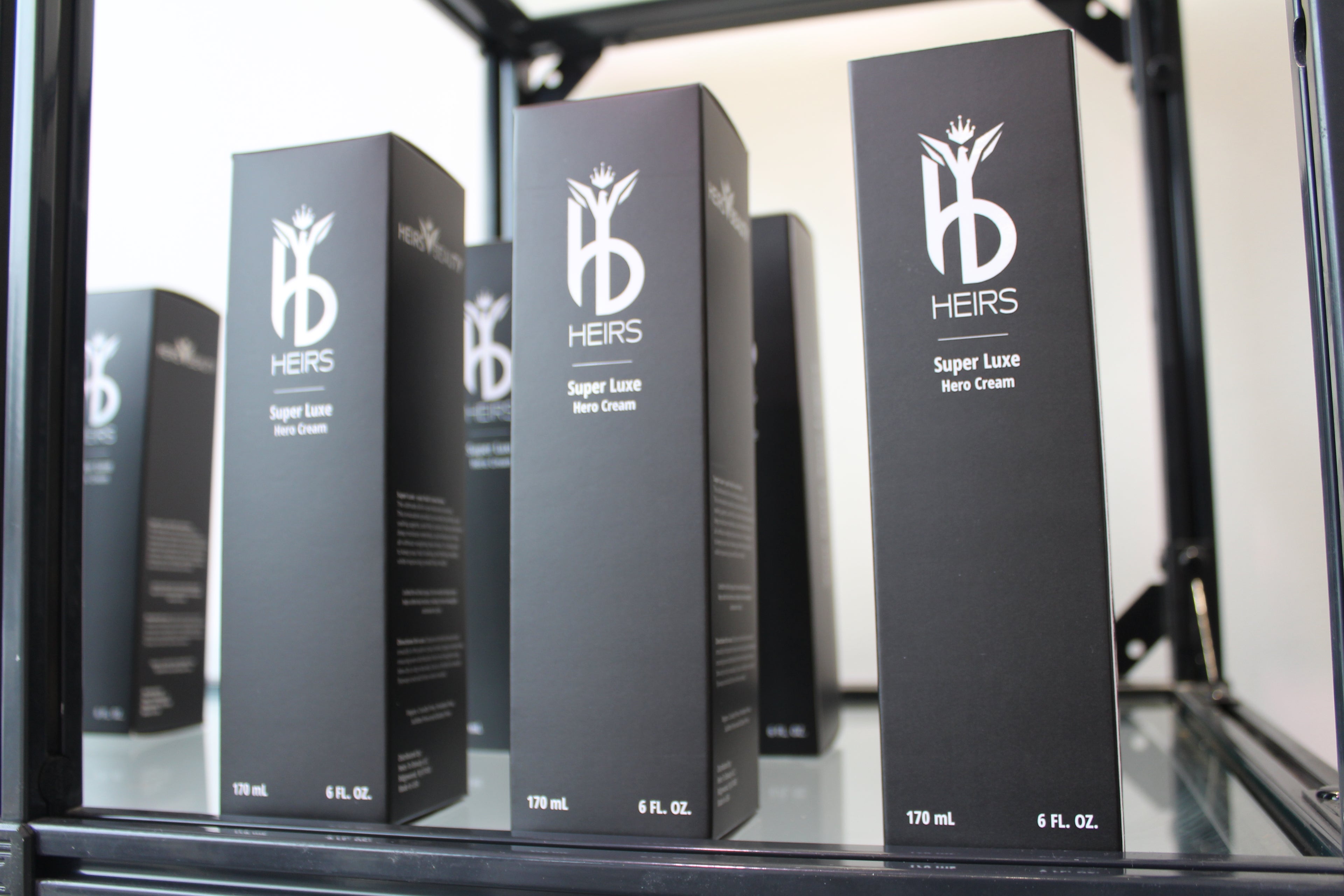 Heirs To Beauty Super Luxe Hero Cream exclusive luxury hair care product with 'HEIRS' branding on a reflective surface