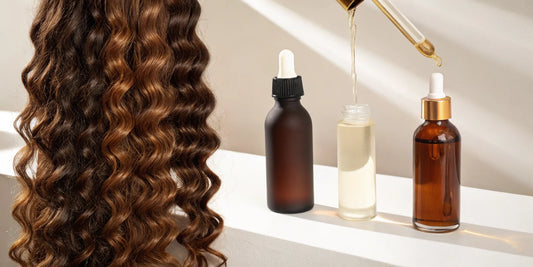 A dropper of hair oil adding a glossy shine to wavy hair.